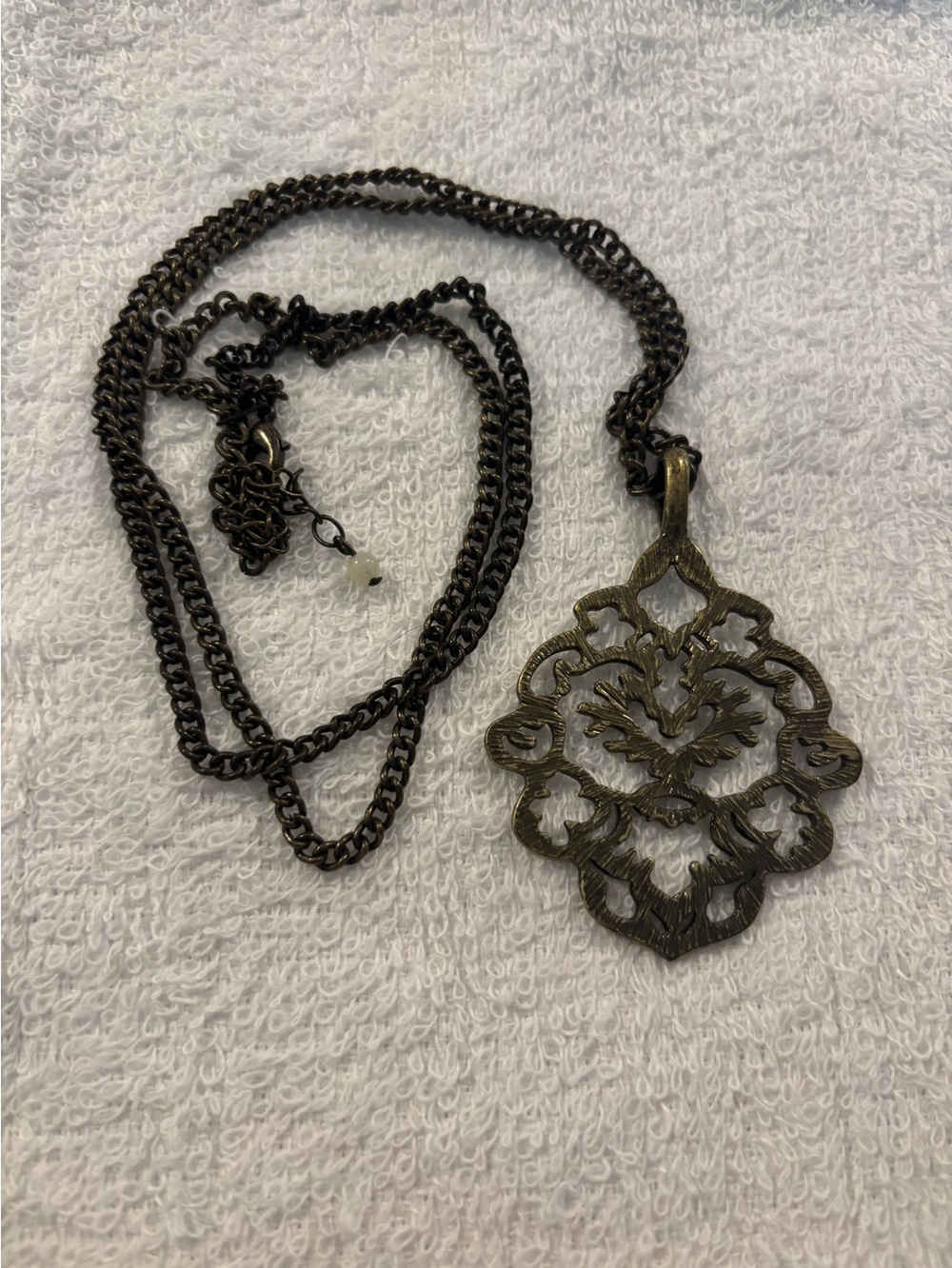 openwork filigree pendant necklace by the brand SAQ